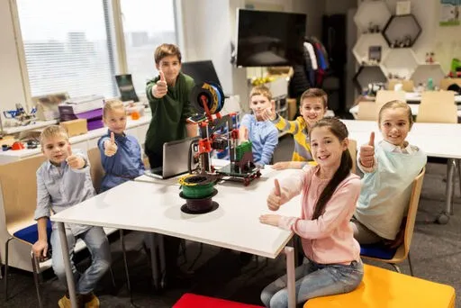 School group giving a thumbs up at a 3D printing workshop
